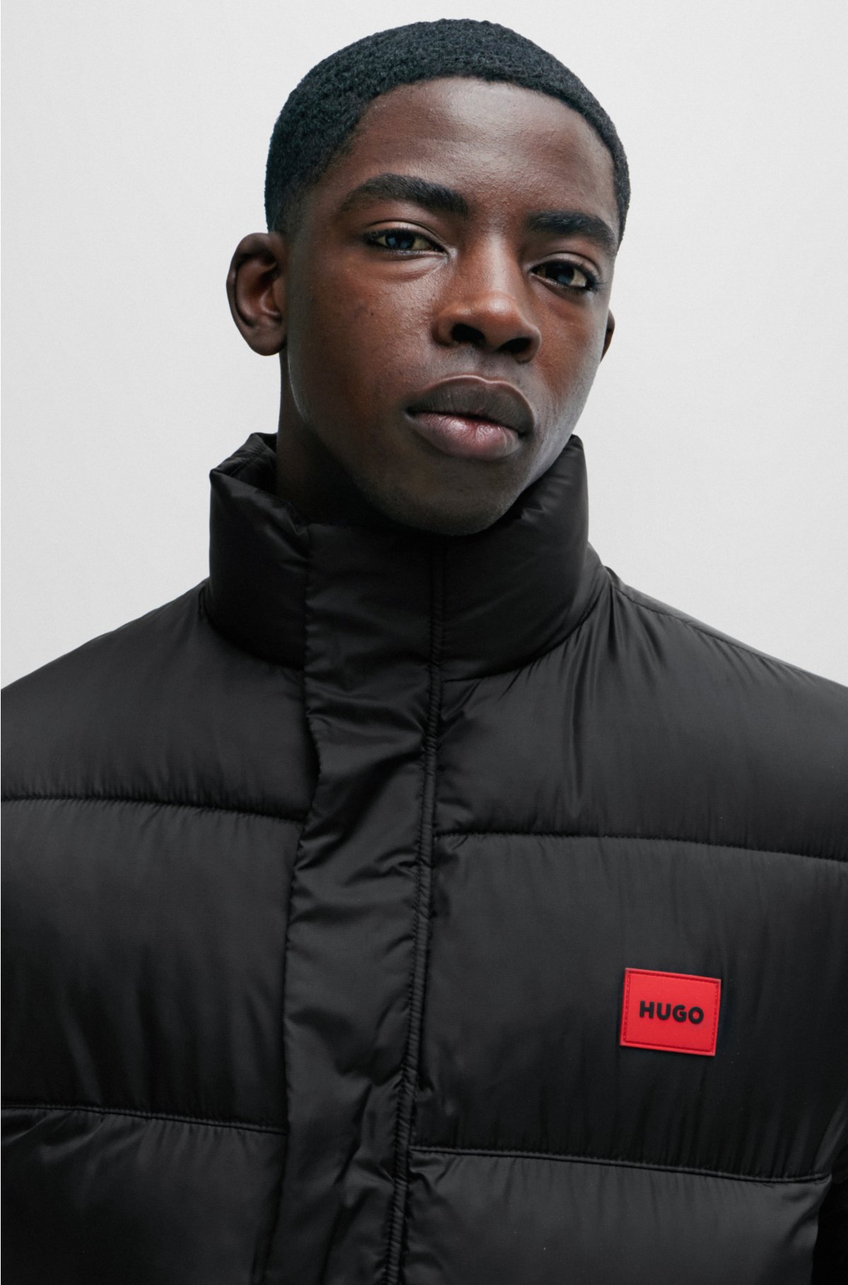 Water-repellent puffer jacket with red logo label, Black
