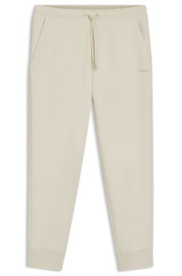 Stretch-cotton tracksuit bottoms with logo print, Natural