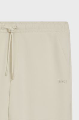 Stretch-cotton tracksuit bottoms with logo print, Natural