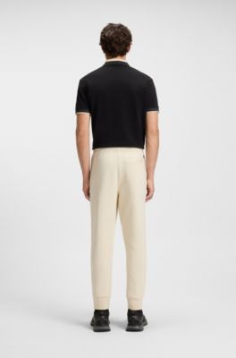 Stretch-cotton tracksuit bottoms with logo print, Natural