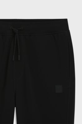 Cotton-terry tracksuit bottoms with logo patch, Black
