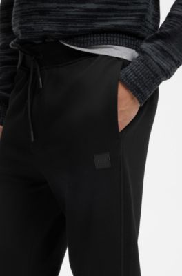 Cotton-terry tracksuit bottoms with logo patch, Black