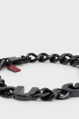 Chain cuff with inserted logo letters, Black