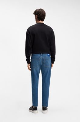 Jeans con fit affusolato in denim elasticizzato blu, Blu