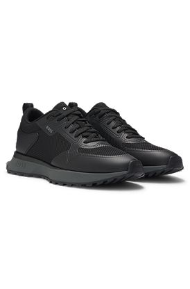 Mixed-material trainers with mesh details and branding