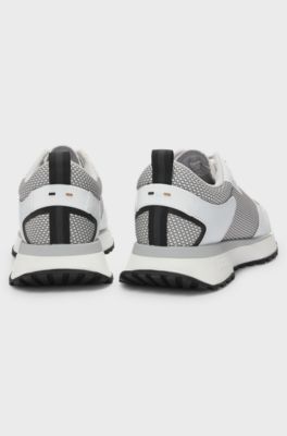 Mixed-material trainers with mesh details and branding, White