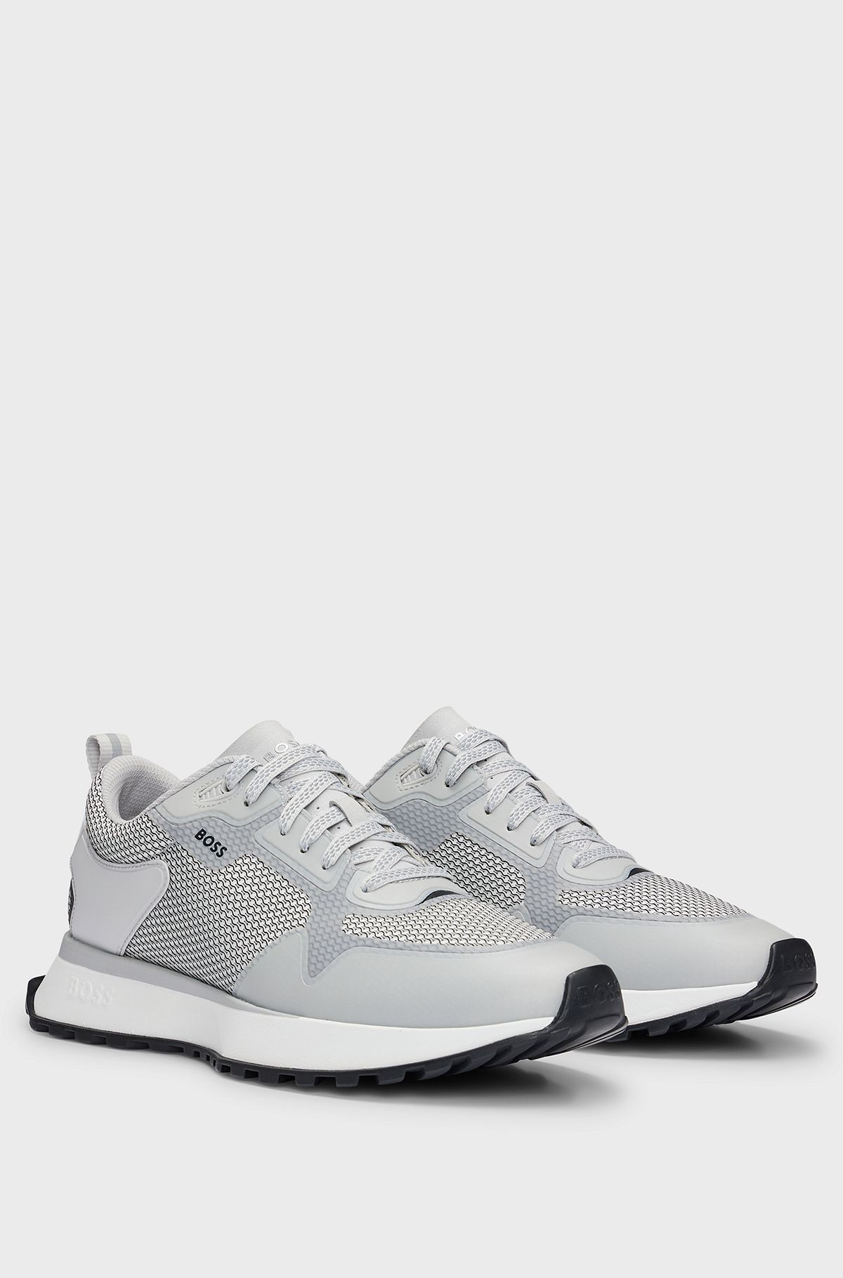 Mixed-material trainers with mesh details and branding, White