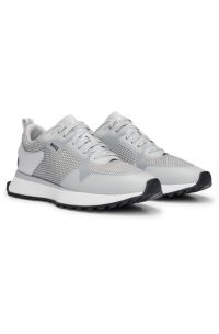 Mixed-material trainers with mesh details and branding, White