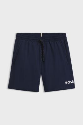 Badeshorts mit kontrastfarbenem Logo und Paspelierung, Dunkelblau