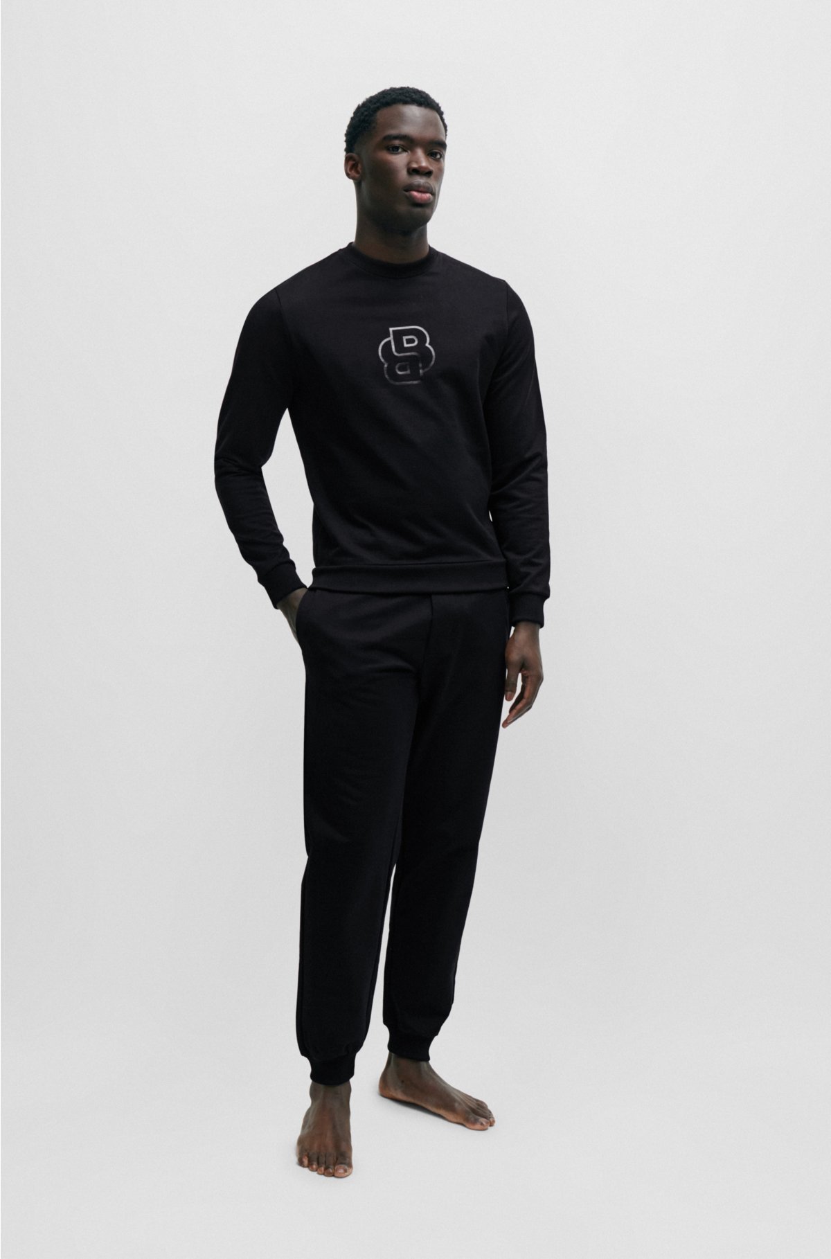 Cuffed tracksuit bottoms in cotton terry with double monogram, Black