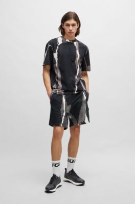 Mixed-material trainers with repeat-logo details, Black