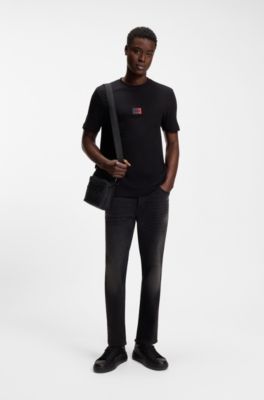 Jeans con fit affusolato in denim elasticizzato nero, Nero