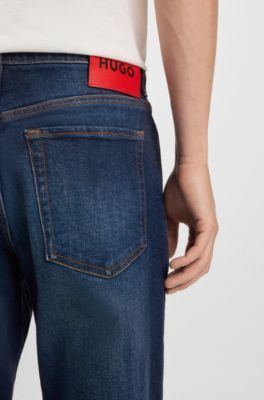 Jeans con fit affusolato in denim elasticizzato blu scuro, Blu scuro