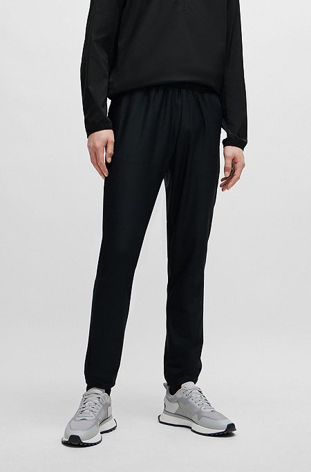 Tracksuit-bukser i stof med stræk og dekorativt, reflekterende logo, Sort