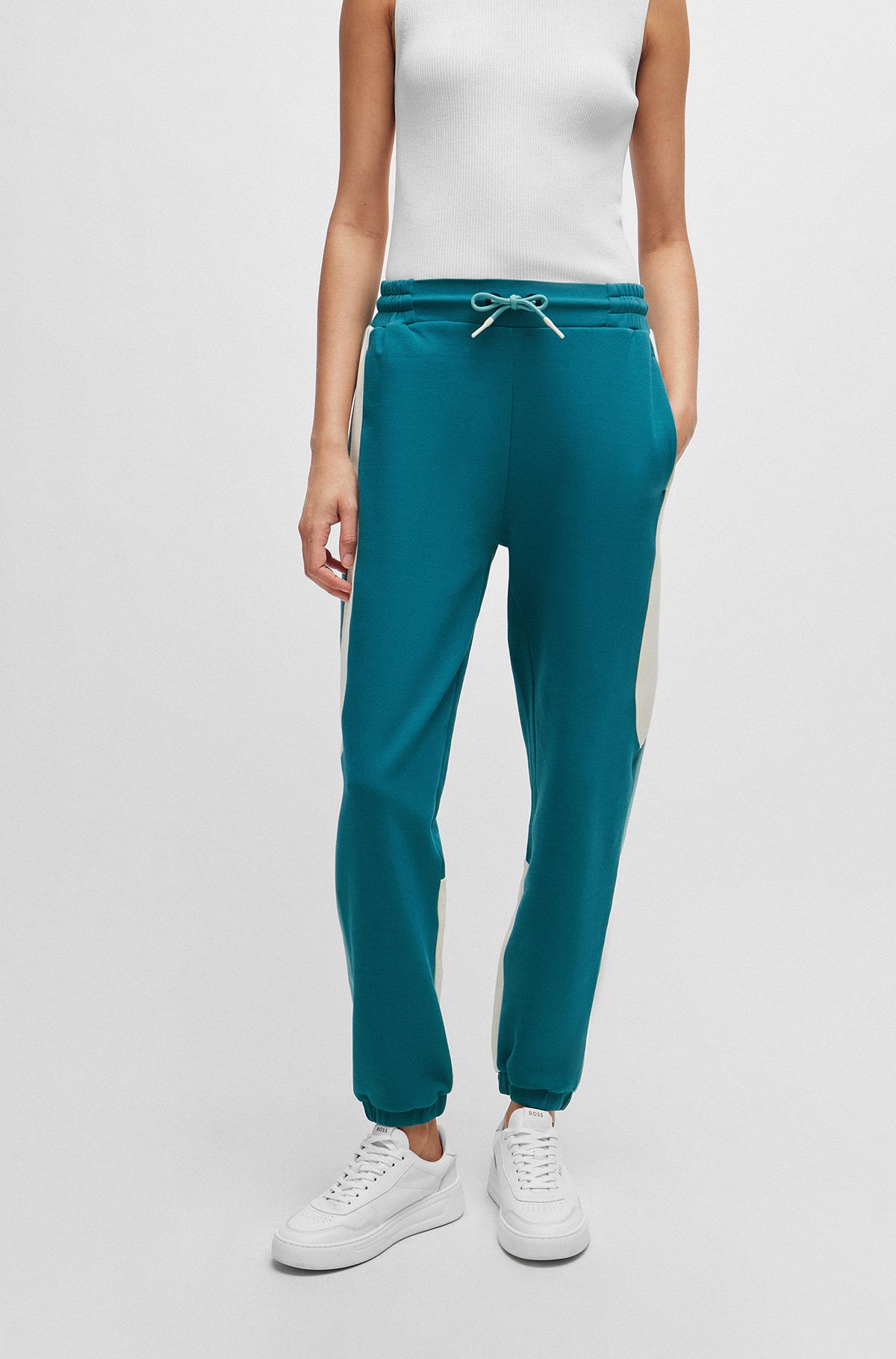 Baggy-fit tracksuit bottoms in stretch fabric, Green