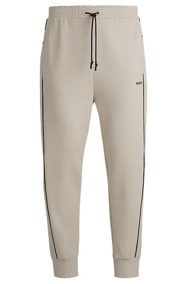 Stretch-cotton tracksuit bottoms with embossed artwork, Natural