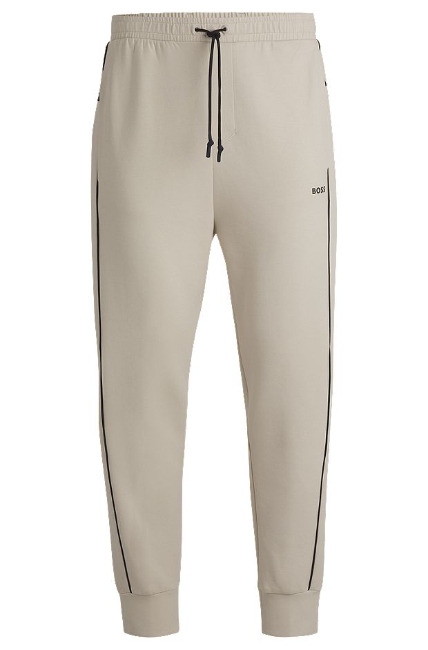 Stretch-cotton tracksuit bottoms with embossed artwork, Natural