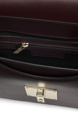 Leather saddle bag with signature hardware and monogram, Dark Red