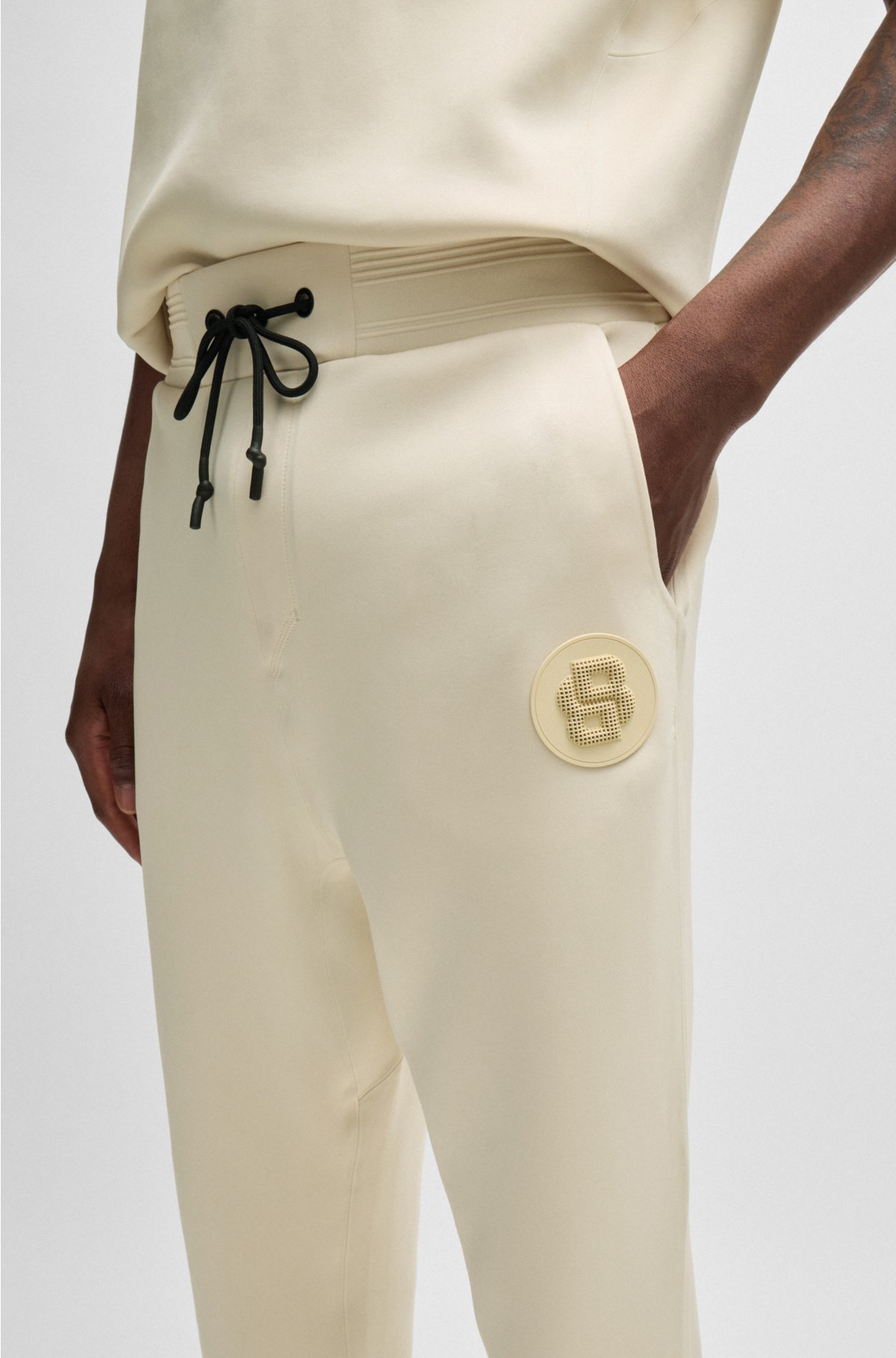 Regular-fit tracksuit bottoms with double-monogram badge, Natural