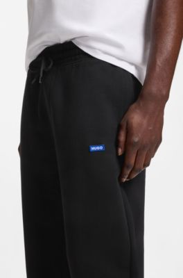 Cotton-terry tracksuit bottoms with logo patch, Black