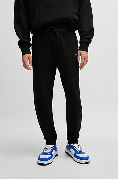 Cotton-terry tracksuit bottoms with blue logo patch, Black