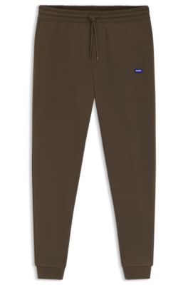 Cotton-terry tracksuit bottoms with blue logo patch, Dark Brown