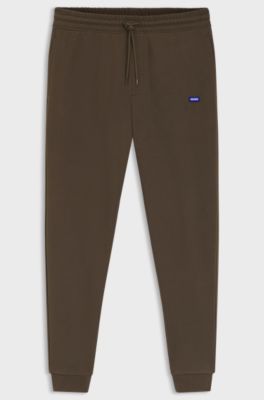 Pantalones de ch&aacute;ndal en felpa de algod&oacute;n con parche de logo, Marr&oacute;n oscuro