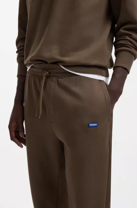 Cotton-terry tracksuit bottoms with blue logo patch