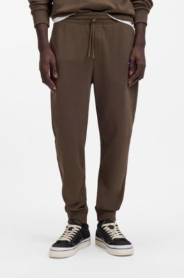 Cotton-terry tracksuit bottoms with blue logo patch, Dark Brown