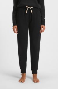 Pantalon de survêtement resserré au bas des jambes avec cordon de serrage à rayures emblématiques, Noir