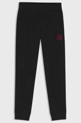 Cuffed tracksuit bottoms in stretch cotton with framed logo, Black