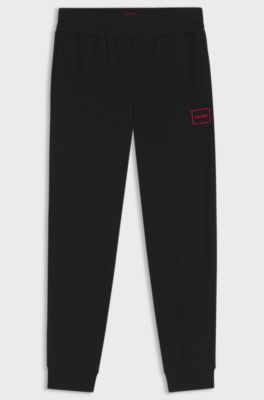 Cuffed loungewear bottoms in stretch cotton with logo print, Black