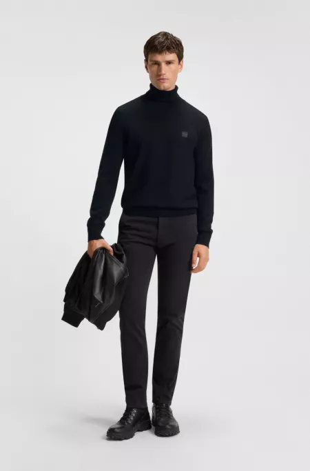 Rollneck sweater in cotton and cashmere with logo patch