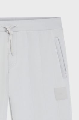 Tracksuit bottoms in a drop-needle cotton blend, Light Grey