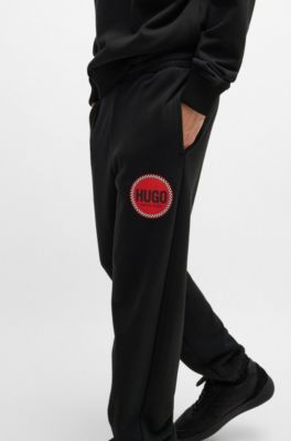 Cotton-terry tracksuit bottoms with logo print, Black