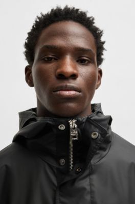 Hooded raincoat with concealed closure, Black