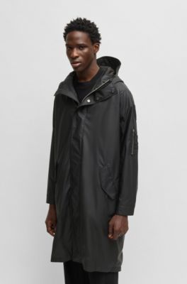 Hooded raincoat with concealed closure, Black