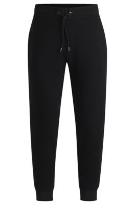 Stretch-cotton tracksuit bottoms with cuffed hems, Black
