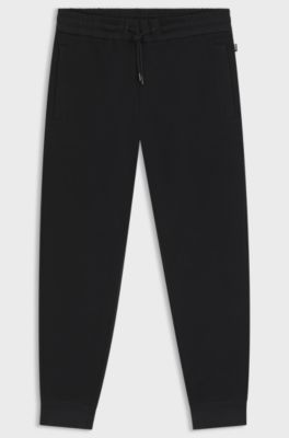 Pantalon de surv&ecirc;tement en coton stretch avec bas de jambes resserr&eacute;s, Noir