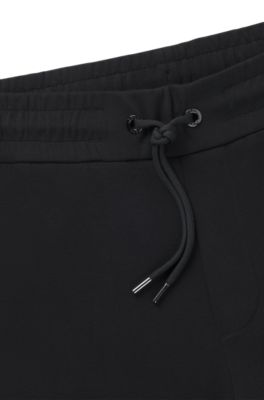 Stretch-cotton tracksuit bottoms with cuffed hems, Black