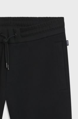 Stretch-cotton tracksuit bottoms with cuffed hems, Black