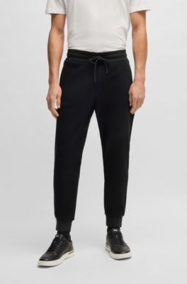 Stretch-cotton tracksuit bottoms with cuffed hems, Black