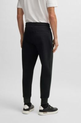 Stretch-cotton tracksuit bottoms with cuffed hems, Black