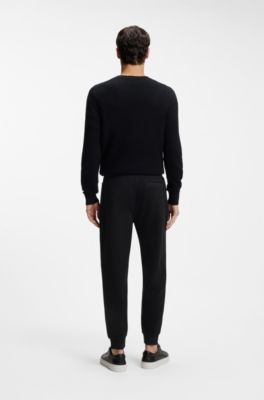 Pantalon de surv&ecirc;tement en coton stretch avec bas de jambes resserr&eacute;s, Noir