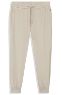 Stretch-cotton tracksuit bottoms with cuffed hems 1