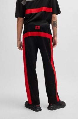 HUGO - HUGO x RB oversized-fit trousers with tape and signature bull ...