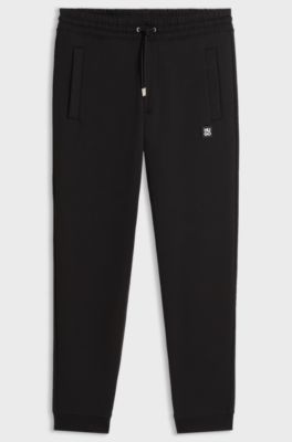 Cotton-blend tracksuit bottoms with stacked logo, Black