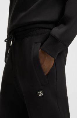 Cotton-blend tracksuit bottoms with stacked logo, Black
