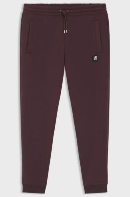 Tracksuit-byxor i bomullsblandning med logga, M&ouml;rkr&ouml;d