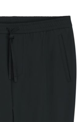 Tapered-fit trousers in water-repellent stretch fabric, Black